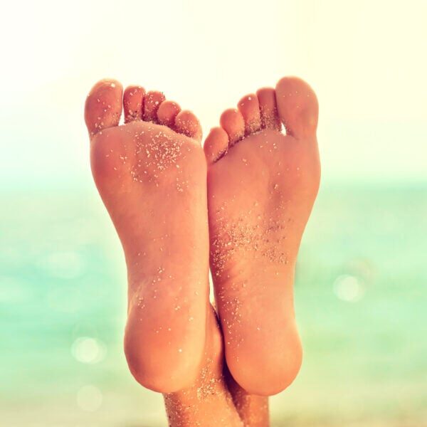 Perfect clean female feet with sea sand on the beach . Spa ,scru